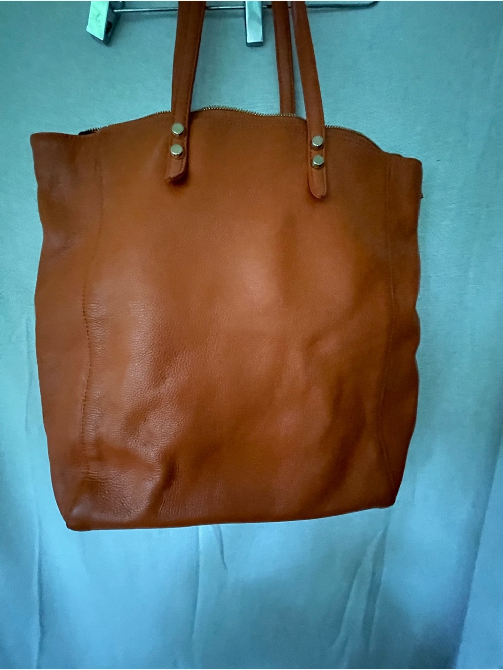 Christopher Kon Orange leather shoulder bag purple lining.